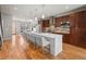 Open kitchen featuring a large island with seating, stainless steel appliances, and hardwood floors at 4529 Vrain St, Denver, CO 80212