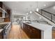 Modern kitchen featuring stainless steel appliances, a large island with seating, and stylish pendant lighting at 4529 Vrain St, Denver, CO 80212