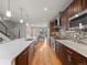 Modern kitchen with stainless steel appliances, large island, and hardwood floors flowing into the dining area at 4529 Vrain St, Denver, CO 80212