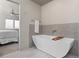 Spa-like bathroom with a sleek standalone tub, tiled accent wall, and modern fixtures, promoting relaxation at 4529 Vrain St, Denver, CO 80212