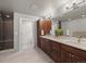 Main bathroom featuring a double vanity with dark wood cabinets, a shower stall and natural light at 4529 Vrain St, Denver, CO 80212