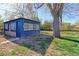 Backyard with a blue garden shed, mature tree, and plenty of space for outdoor activities at 4580 Balsam St, Wheat Ridge, CO 80033
