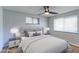 Cozy bedroom featuring a ceiling fan, neutral decor, hardwood floors, and bright natural light at 4580 Balsam St, Wheat Ridge, CO 80033