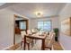 Elegant dining room with modern light fixture, large window, and seating for six around a wooden table at 4580 Balsam St, Wheat Ridge, CO 80033