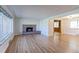 Bright living room with hardwood floors and brick fireplace, bathed in natural light at 4580 Balsam St, Wheat Ridge, CO 80033