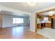 Spacious living room flows into updated kitchen with stainless steel appliances and wood cabinets at 4580 Balsam St, Wheat Ridge, CO 80033