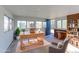 Home office with built-in shelving, desk, natural light, and a separate entrance to the backyard at 4580 Balsam St, Wheat Ridge, CO 80033