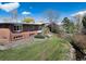Expansive backyard with lush green lawn and mature trees, offering a serene and private outdoor space at 7000 Highland Dr, Lakewood, CO 80214