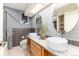 Modern bathroom showcasing dual sinks, a granite countertop, sleek fixtures, and stylish tiling at 7000 Highland Dr, Lakewood, CO 80214