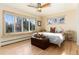 Bright bedroom with large windows offering natural light and views of mature trees at 7000 Highland Dr, Lakewood, CO 80214
