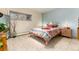 A bedroom boasts natural light with a bed, stylish linens, and a decorative mirror and nightstand at 7000 Highland Dr, Lakewood, CO 80214