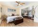 Comfortable bedroom with natural wood flooring, ceiling fan, and sliding doors at 7000 Highland Dr, Lakewood, CO 80214