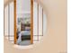 Unique view into a bedroom featuring a wooden headboard and decorative throw blanket at 7000 Highland Dr, Lakewood, CO 80214
