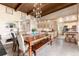Open dining area features a dark wood table, unique light fixture, and easy access to the kitchen at 7000 Highland Dr, Lakewood, CO 80214