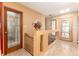 Stylish foyer featuring unique terrazzo flooring, contemporary art, and custom stained-glass doors at 7000 Highland Dr, Lakewood, CO 80214
