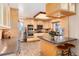 Modern kitchen featuring light wood cabinetry, stainless steel appliances, and a breakfast bar at 7000 Highland Dr, Lakewood, CO 80214