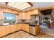Bright kitchen with updated appliances, light wood cabinets, and a large window with beautiful views at 7000 Highland Dr, Lakewood, CO 80214