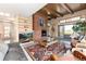 Spacious living room with brick fireplace, built-in shelves, hardwood floors, and views of the outdoors at 7000 Highland Dr, Lakewood, CO 80214