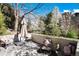 This serene patio offers relaxing seating and lovely views of the surrounding landscaped gardens and trees at 7000 Highland Dr, Lakewood, CO 80214