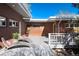 Outdoor patio features a seating area with lounge chairs, a brick exterior, and a serene environment at 7000 Highland Dr, Lakewood, CO 80214