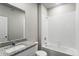 Well-lit bathroom with granite countertop, vanity and white tile shower and tub at 7208 Dolores Ave, Frederick, CO 80530