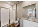 Well-lit bathroom with tiled walk-in shower, granite countertop vanity, and wood-look flooring at 7208 Dolores Ave, Frederick, CO 80530