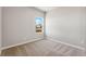 Neutral bedroom with large window, plush carpet, and views of the neighborhood at 7208 Dolores Ave, Frederick, CO 80530