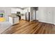 Open-concept kitchen with stainless steel appliances, granite countertops and wood flooring at 7208 Dolores Ave, Frederick, CO 80530