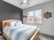 Bright bedroom with a ceiling fan, nautical decor, and a large window with natural light at 837 E 98Th Ave # 403, Thornton, CO 80229