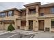 Exterior view of townhome units with stucco and stone accents and private garages at 837 E 98Th Ave # 403, Thornton, CO 80229