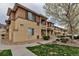 Inviting condo complex with well-manicured lawn and pathway leading to attractive earth-tone stucco units at 837 E 98Th Ave # 403, Thornton, CO 80229