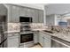 Modern kitchen featuring granite countertops, stainless steel appliances and gray cabinets at 837 E 98Th Ave # 403, Thornton, CO 80229