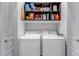 Functional laundry room with side by side washer and dryer and shelving above at 837 E 98Th Ave # 403, Thornton, CO 80229