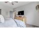 Comfortable main bedroom featuring a ceiling fan, large window, and television at 837 E 98Th Ave # 403, Thornton, CO 80229