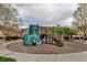 Community playground with climbing structures, slides, and trees in a residential area at 837 E 98Th Ave # 403, Thornton, CO 80229
