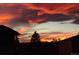Beautiful sunset view with orange and red clouds over the silhouettes of houses and trees at 837 E 98Th Ave # 403, Thornton, CO 80229