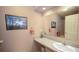 Well-lit bathroom with vanity, mirror, and nautical-themed accents at 7656 Depew St # 1802, Arvada, CO 80003