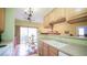 Bright open kitchen with a modern sink, wooden cabinets, and an adjacent dining area at 7656 Depew St # 1802, Arvada, CO 80003