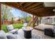 Relaxing backyard patio with a fire pit, comfortable seating, and a lush green lawn at 9574 Las Colinas Dr, Lone Tree, CO 80124