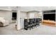 Finished basement with a sofa, bar-style seating, and entertainment area with two wall-mounted TVs at 9574 Las Colinas Dr, Lone Tree, CO 80124
