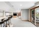 Spacious basement rec room with bar seating, entertainment area, and sliding door access to outdoor patio at 9574 Las Colinas Dr, Lone Tree, CO 80124