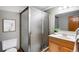 Bathroom features a glass-enclosed shower, vanity with wood cabinetry, and neutral color palette at 9574 Las Colinas Dr, Lone Tree, CO 80124