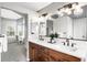 Bright bathroom featuring a double vanity, quartz countertop, modern fixtures, and an adjacent eating area at 9574 Las Colinas Dr, Lone Tree, CO 80124