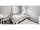 Cozy bedroom with grey walls, white furniture, soft pink accents, and a fluffy white rug at 9574 Las Colinas Dr, Lone Tree, CO 80124
