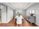Elegant dining room with stylish chandelier, hardwood floors, and modern buffet at 9574 Las Colinas Dr, Lone Tree, CO 80124
