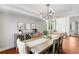 Elegant dining room features a stylish light fixture, a modern buffet, and wood floors at 9574 Las Colinas Dr, Lone Tree, CO 80124
