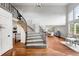 Grand entryway with wood floors, staircase, and view of open-concept dining and living areas at 9574 Las Colinas Dr, Lone Tree, CO 80124