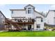 Exterior view of home featuring a deck and patio for entertaining with lush grassy yard at 9574 Las Colinas Dr, Lone Tree, CO 80124
