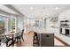 Bright kitchen with stainless steel appliances and view to the dining area at 9574 Las Colinas Dr, Lone Tree, CO 80124