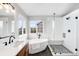 Modern main bathroom featuring a soaking tub, glass shower, and dual vanity at 9574 Las Colinas Dr, Lone Tree, CO 80124